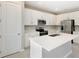 Modern kitchen featuring white cabinets, stainless steel appliances, and a quartz island at 645 Summit River Dr, Apopka, FL 32712