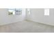 Bright, carpeted bedroom with ample natural light from windows, showcasing a calm, neutral space at 655 Summit River Dr, Apopka, FL 32712