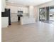 Open-concept kitchen with stainless steel appliances and an island, flowing into a spacious living area at 655 Summit River Dr, Apopka, FL 32712