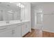 Bathroom featuring double sinks, a large mirror, modern fixtures, and a walk-in closet at 660 Summit River Dr, Apopka, FL 32712