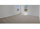 Bright bedroom featuring neutral carpet, natural light from the two windows, and light-colored walls at 660 Summit River Dr, Apopka, FL 32712