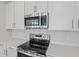 Close up of a well-equipped kitchen featuring stainless steel appliances and stylish countertops at 660 Summit River Dr, Apopka, FL 32712