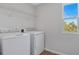 Laundry room with new washer and dryer, bright light, and wood-look floors at 660 Summit River Dr, Apopka, FL 32712