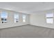 Bright, carpeted bedroom with ample natural light from multiple windows offers a calm and inviting space at 665 Summit River Dr, Apopka, FL 32712