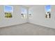 Bright, carpeted bedroom with ample natural light from multiple windows offers a calm and inviting space at 665 Summit River Dr, Apopka, FL 32712