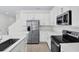 Modern kitchen with white cabinets, stainless steel appliances, a large island, and wood-look flooring at 665 Summit River Dr, Apopka, FL 32712