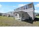 View of backyard and covered patio area, with exterior of house showcasing modern design at 675 Summit River Dr, Apopka, FL 32712