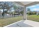 Covered patio overlooking a spacious backyard with mature trees and a privacy fence at 675 Summit River Dr, Apopka, FL 32712