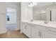 Elegant bathroom with double vanity, tiled floor, and walk-in shower with glass door and closet at 675 Summit River Dr, Apopka, FL 32712
