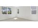 Bright, empty bedroom featuring tiled flooring and natural light streaming from the large windows at 675 Summit River Dr, Apopka, FL 32712