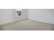 Bright bedroom featuring neutral carpeting and a large window with a view of the neighborhood at 675 Summit River Dr, Apopka, FL 32712