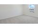 Empty bedroom featuring neutral walls, plush carpeting, and a window at 675 Summit River Dr, Apopka, FL 32712