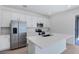 Contemporary kitchen featuring white cabinets, a center island, stainless steel appliances, and modern finishes at 675 Summit River Dr, Apopka, FL 32712