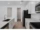 Modern kitchen with stainless steel appliances, white cabinetry, and a walk-in pantry at 675 Summit River Dr, Apopka, FL 32712