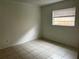 Bedroom with tiled floors and natural light coming through the window at 731 Michigan Ct # 1, St Cloud, FL 34769