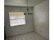 Dining area showcasing tiled floor, overhead lighting, and a bright window at 731 Michigan Ct # 1, St Cloud, FL 34769