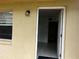 Close up of the unit entrance, showcasing the door and exterior lighting fixture at 731 Michigan Ct # 1, St Cloud, FL 34769