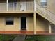 Exterior view of the property featuring a stairway and front entrance at 731 Michigan Ct # 1, St Cloud, FL 34769