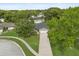 Aerial view of a charming home featuring a well-manicured lawn, mature trees, and a long driveway at 736 Forest Glen Ct, Maitland, FL 32751