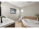 Bright bathroom with a large soaking tub, white vanity, and tile flooring at 736 Forest Glen Ct, Maitland, FL 32751