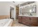 Well-lit bathroom with double vanity, a soaking tub, and a separate walk-in shower at 736 Forest Glen Ct, Maitland, FL 32751