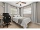 Bright bedroom showcasing natural light, a comfortable bed, and a dedicated workspace with desk at 736 Forest Glen Ct, Maitland, FL 32751