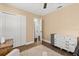 Sunlit bedroom boasts hardwood floors, closet space and features a comfy seat to relax and unwind at 736 Forest Glen Ct, Maitland, FL 32751