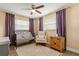 Bedroom featuring a metal crib, a comfy chair, and a wooden cabinet, illuminated by natural light at 736 Forest Glen Ct, Maitland, FL 32751