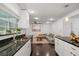 Open kitchen with white cabinets, dark countertops, and view into the well-lit living area at 736 Forest Glen Ct, Maitland, FL 32751