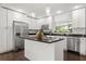 Bright kitchen featuring white cabinets, stainless steel appliances, and a functional center island at 736 Forest Glen Ct, Maitland, FL 32751