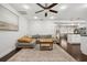 Open-concept living room with dark wood floors, ceiling fan, and an open layout to the kitchen at 736 Forest Glen Ct, Maitland, FL 32751