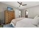 Cozy main bedroom featuring wood-style flooring, a ceiling fan, and ensuite bathroom access at 736 Forest Glen Ct, Maitland, FL 32751