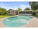 A backyard featuring a large in-ground pool with a screened-in lanai and green lawn at 736 Forest Glen Ct, Maitland, FL 32751