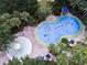 Aerial view of a splash pad and pool surrounded by palm trees, offering Gathering fun in the sun at 1106 Gran Bahama Blvd # 1106, Davenport, FL 33897