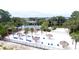 An aerial view of the community's white sand beach, volleyball court, pool, and tiki huts at 1106 Gran Bahama Blvd # 1106, Davenport, FL 33897