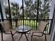 Relaxing balcony with seating and a view of the well-manicured backyard at 1106 Gran Bahama Blvd # 1106, Davenport, FL 33897