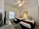 Bright bedroom features two twin beds, ceiling fan, and light wood flooring at 1106 Gran Bahama Blvd # 1106, Davenport, FL 33897