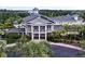 Stunning exterior view of community clubhouse with lush landscaping, palm trees, and vibrant foliage at 1106 Gran Bahama Blvd # 1106, Davenport, FL 33897