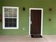 Condo front entrance with green siding, white trim, and visible unit number at 1106 Gran Bahama Blvd # 1106, Davenport, FL 33897