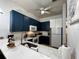 Well-lit kitchen with dark blue cabinets, a white countertop, and stainless steel appliances at 1106 Gran Bahama Blvd # 1106, Davenport, FL 33897