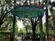 Playful splashpad sign with cartoon animals surrounded by lush trees and colorful play equipment at 1106 Gran Bahama Blvd # 1106, Davenport, FL 33897