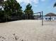 Sandy volleyball court near the lake, surrounded by palm trees and beach chairs at 1106 Gran Bahama Blvd # 1106, Davenport, FL 33897
