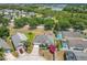 Aerial view of the home nestled in a serene community with lush greenery, a pond and neighborhood pool at 116 Westport Ln, Davenport, FL 33896