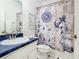 Nautical-themed bathroom with blue countertops, ship-patterned shower curtain, and a modern sink at 116 Westport Ln, Davenport, FL 33896