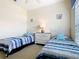 Bright bedroom featuring two twin beds, ceiling fan, and dresser at 116 Westport Ln, Davenport, FL 33896