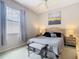 Cozy bedroom with a large window and neutral decor at 116 Westport Ln, Davenport, FL 33896