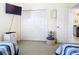 Bedroom boasts closet, TV, and nautical themed decor at 116 Westport Ln, Davenport, FL 33896