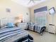 Bedroom features two twin beds, a ceiling fan, and a TV at 116 Westport Ln, Davenport, FL 33896