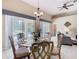 Dining room with glass top table, and views of the pool area through sliding glass doors at 116 Westport Ln, Davenport, FL 33896