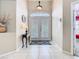 Bright foyer featuring tile flooring, neutral walls, decorative console table, and a front door with transom window at 116 Westport Ln, Davenport, FL 33896